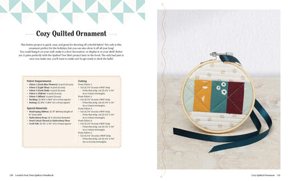 A small quilted ornament with colorful geometric fabrics rests on a light surface beside Lorelai's First-Time Quilter's Handbook by Checker Distributor—perfect inspiration for beginner quilt projects.