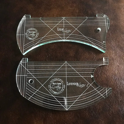 The White Arbor Quilting Lilac & Lavender Duo Ruler Set includes two clear acrylic templates with white grids, circular holes, and engraved branding—perfect as continuous curve rulers on dark brown textured surfaces.