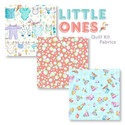 The Quilted Joy Little Ones Quilt Kit features three fabrics: baby clothes on a clothesline, pink with colorful bubbles, and blue grid with toys and blocks. Ideal for nursery quilts. Text: “Little Ones Quilt Kit Fabrics.”.