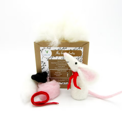The Feather Felts White Mouse - Needle Felting Kit No Foam includes supplies, loose wool, pink ears, a black hat, red scarf and yarn, pink wool, and instructions to create a felted white mouse—displayed on a white background.