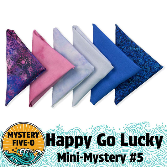 Five fabric triangles in purple, pink, lavender, blue, and navy are arranged in a row. Below is "Mystery Five-0 Pixie Prism 'Happy Go Lucky' Quilt Kit" by Quilted Joy—ideal for the Mystery Five-0 Facebook Group and fat quarter quilt kit fans.