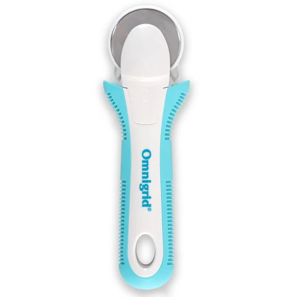 The Tacony Corporation Omnigrid 12 x 18 Compact Rotary Cutting Kit features an ergonomic white and turquoise rotary cutter with a circular metal blade—perfect for easily cutting fabric or paper with your favorite cutting mat.