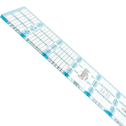 The Omnigrid 12 x 18 Compact Rotary Cutting Kit by Tacony Corporation features a clear quilting ruler with blue grid lines, measurements, and markings—perfect for use with your rotary cutter or folding cutting mat.