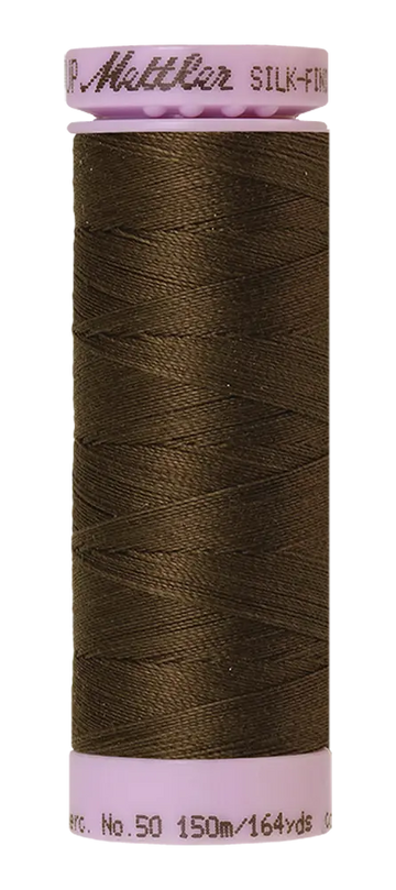 A spool of olive Mettler Cotton Silk Finish 50wt quilting thread, 150m/164yds, with a light pink base and cap.