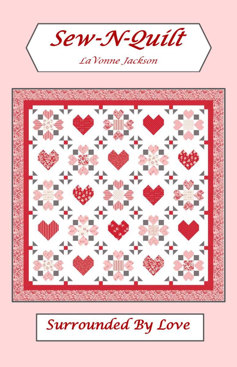 A quilt pattern named "Surrounded by Love" from Riley Blake, featuring red and pink heart and geometric motifs on a white background with a matching border; text includes Sew-N-Quilt, LaVonne Jackson, Surrounded by Love, Riley Blake.