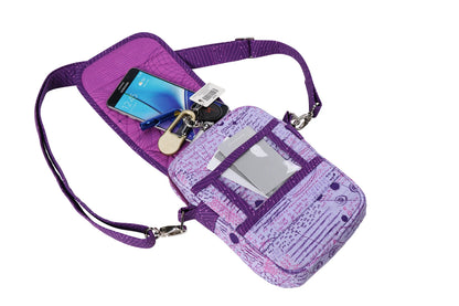The On the Go 2.0 Quilt Pattern is a small purple crossbody bag with a unique quilt pattern, featuring a clear front pocket holding a white card, and an open compartment showing keys and a smartphone against a white background.