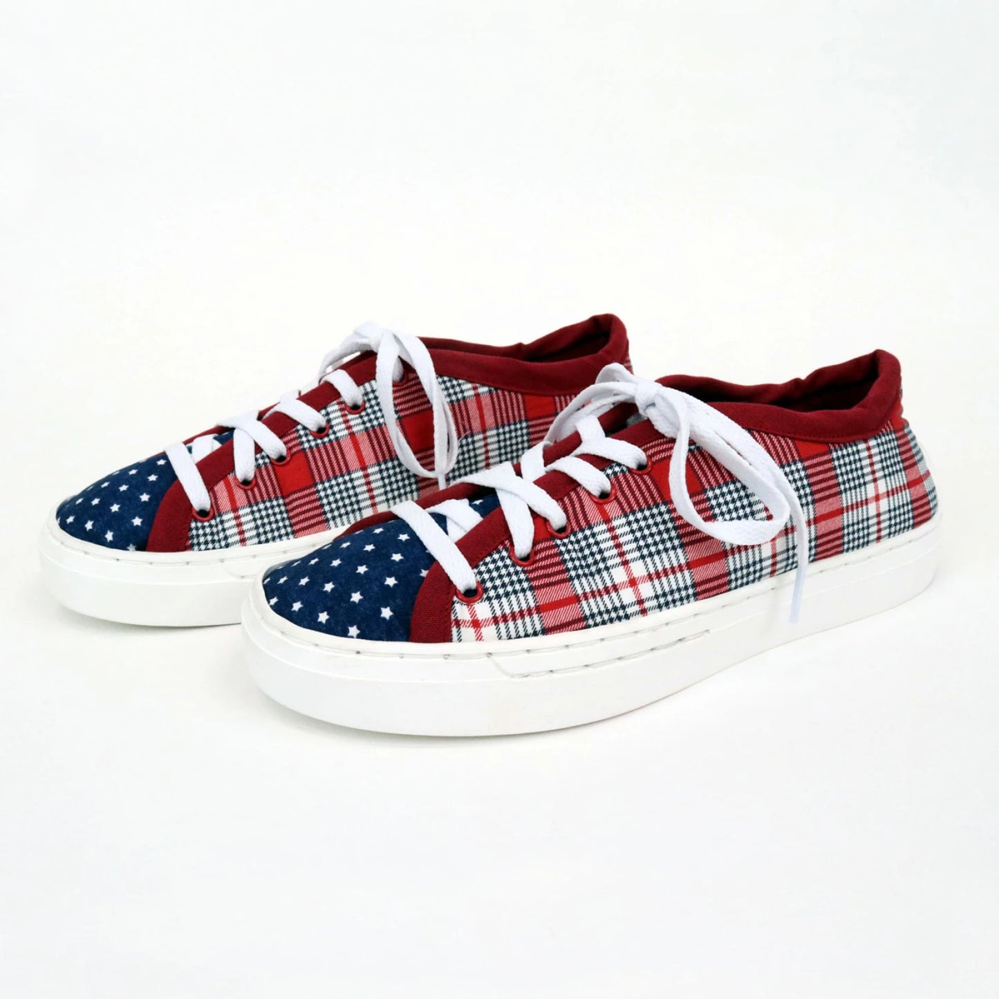Customize your own Patchwork Kicks White Shoe Kit by Checker Distributor—low-top sneakers with white soles, a red, white, and blue plaid pattern on the sides, red trim, blue starry toe caps, and crisp white laces. Perfect for sneaker DIY projects!.