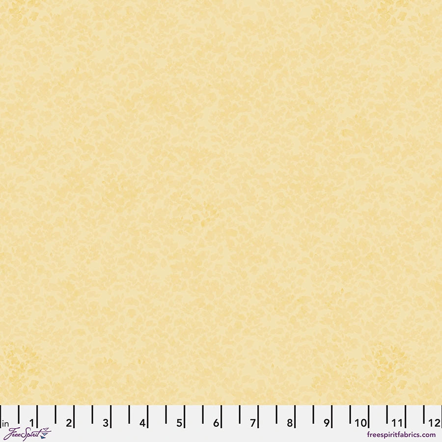 Chromatics Butter Foliage Fabric Yardage by Jaftex - FreeSpirit is a light yellow, textured quilting cotton with a subtle mottled pattern. Features a measuring ruler in inches (0–12) along the bottom edge—ideal for your next project.