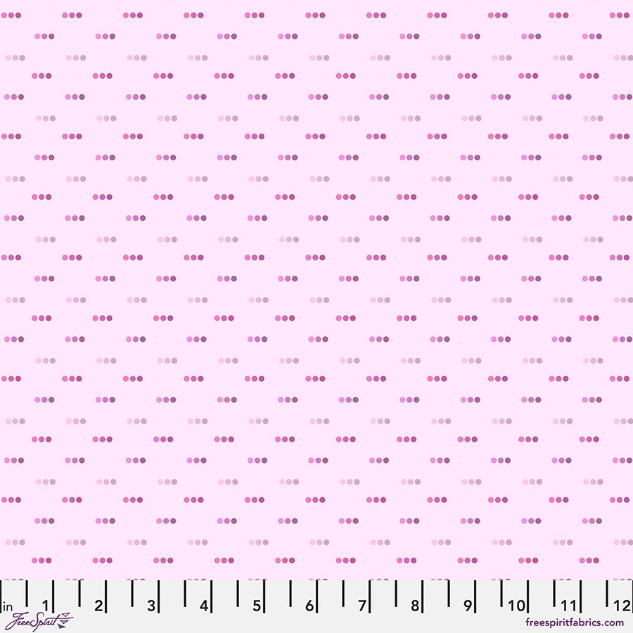 The Chromatics Bubblegum Dotty Fabric Yardage by Jaftex - FreeSpirit is a 100% cotton quilting fabric in pink with rows of clustered dark and light pink dots. A ruler along the bottom shows measurements in inches from 1 to 12.