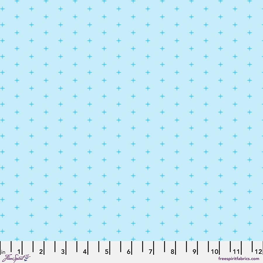 Chromatics Sky Cross Stitch Fabric Yardage by Jaftex - FreeSpirit features light blue quilting fabric with small, evenly spaced dark blue plus signs and a white measuring scale (1–12 inches) along the bottom edge. Branding appears in the lower corners.