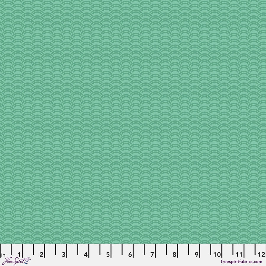 The Chromatics Jade Crescent Fabric Yardage by Jaftex - FreeSpirit is a light teal cotton quilting fabric with a repeating scallop wave pattern. A white measuring tape (0-12 inches) runs along the bottom, and freespiritfabrics.com appears in the lower right corner.