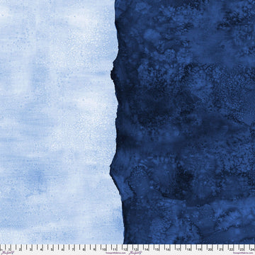 A textured fabric with a jagged, torn edge dividing light blue on the left and dark blue on the right; a white measuring tape runs along the bottom edge, marked in inches.