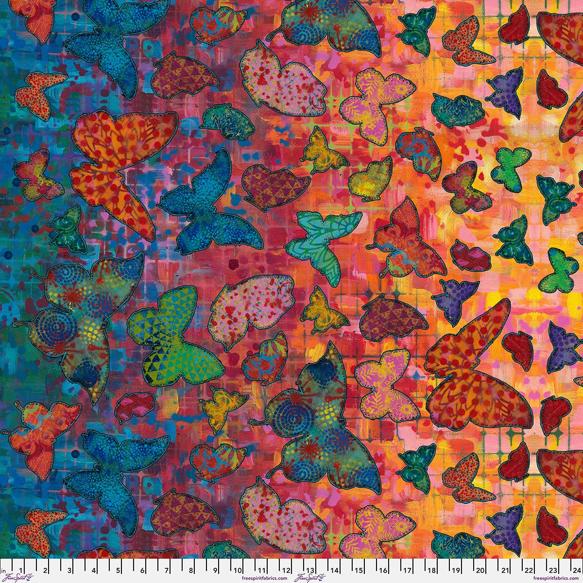 Wings of Wonder Multi Wings Fabric Yardage by Jaftex - FreeSpirit features vibrant red, blue, green, and yellow butterflies on a rainbow gradient. Perfect multicolor cotton for quilting. A white measuring ruler lines the bottom edge.