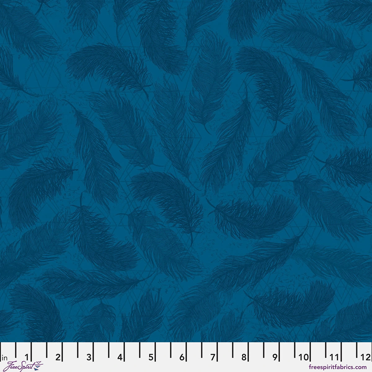 The Wisdom Indigo The Whispers Fabric Yardage by Jaftex - FreeSpirit is a quilting cotton featuring a repeating dark teal feather pattern on blue shades, shown with a ruler in inches 0–12 along the bottom edge.