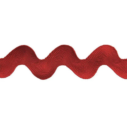 A close-up of Rick Rack 1-1/4" Wide red polyester trim with a wavy zigzag pattern on a white background—ideal as a sewing embellishment.
