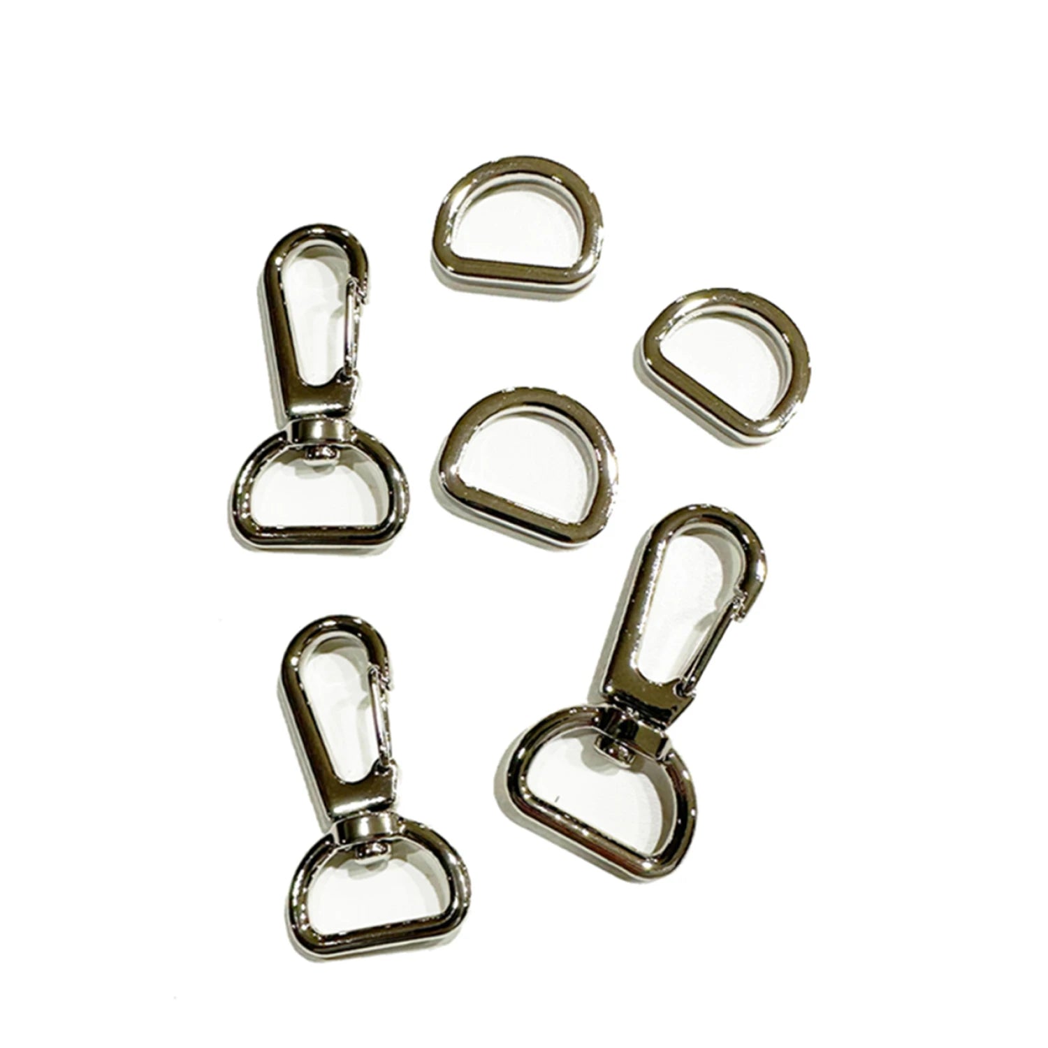 The Quick Zippy Pouch Hardware Kit by Checker Distributor includes three silver swivel hooks with matching D-rings, shown on a white background in a casual arrangement.