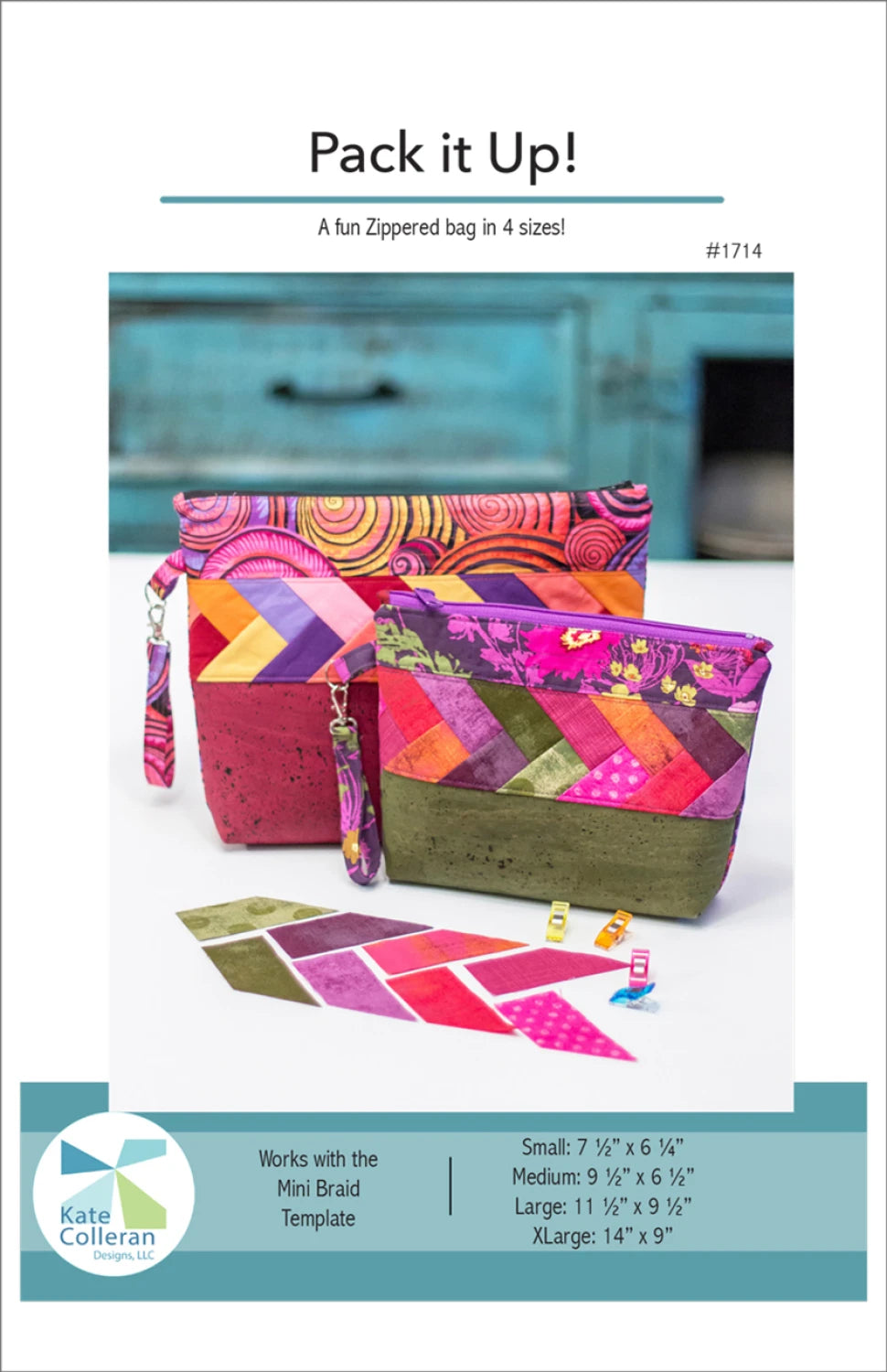 The Pack it Up Pattern by Checker Distributor features two colorful, quilted zippered bags with patchwork designs and braid detail on a wooden surface. Smaller fabric pieces and a turquoise drawer appear in the background. Available in four sizes.