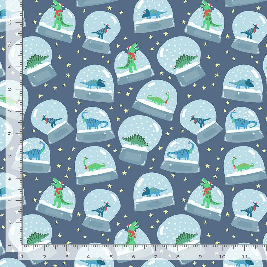 Don't Claus A Scene Sapphire I Want To Break Free Fabric Yardage by Dear Stella features colorful cartoon dinosaurs in snow globes on a blue background with yellow stars. Ruler shown for scale in inches—perfect for dinosaur fabric lovers!.