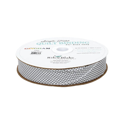 A spool of Riley Blake Micro Gingham Gray 2.5" Bias Quilt Binding, made from 100% cotton, with branded labeling.