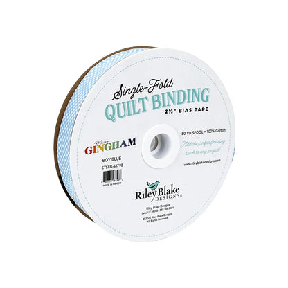 Riley Blake Micro Gingham Boy Blue 2.5" bias quilt binding, 100% cotton, on a white spool with blue and black text.