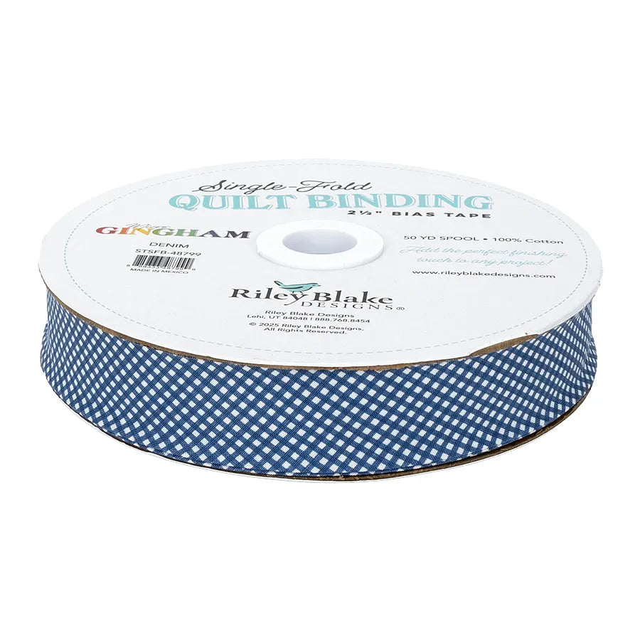 A 50-yard spool of Riley Blake Micro Gingham Denim 2.5" Bias Quilt Binding in blue and white, made from 100% cotton.
