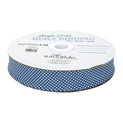A 50-yard spool of Riley Blake Micro Gingham Denim 2.5" Bias Quilt Binding in blue and white, made from 100% cotton.