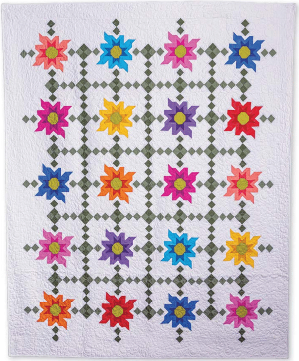 The Quilted Joy Love of Quilting Wildflower Blossoms Quilt Kit features sixteen vibrant star blocks with green geometric sashing on a white background, creating a colorful modern quilt that's perfect for your next project.