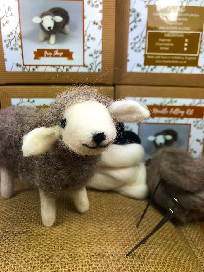 The Feather Felts Grey Sheep - Needle Felting Kit No Foam features a felted sheep figurine, ideal for beginners or anyone seeking a fun sheep needle felting project using quality materials.