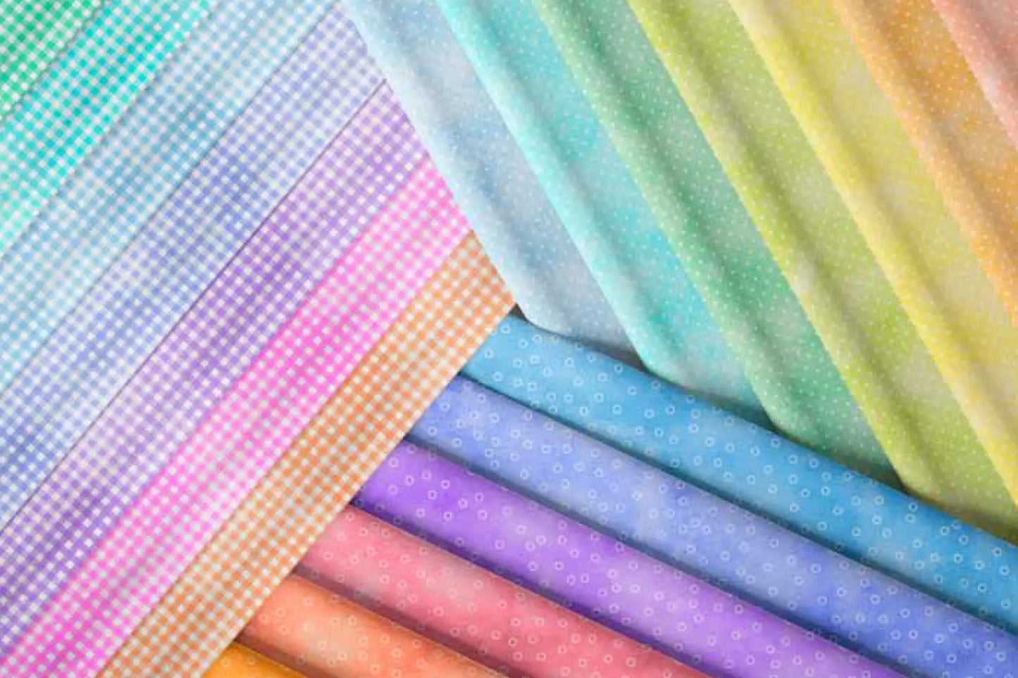 Sorbet 5" Charm Packs display an array of pastel fabric swatches in a fan, highlighting quilting patterns and textures like gingham checks, polka dots, and subtle prints.