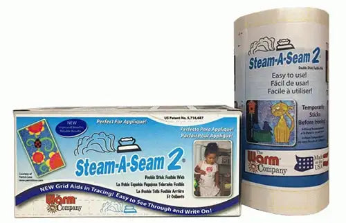 A box and a roll of Steam-A-Seam 2 fusible web by Warm Company are shown. The packaging highlights that it is easy to use, perfect for appliqué, and features grid aids for tracing and writing.