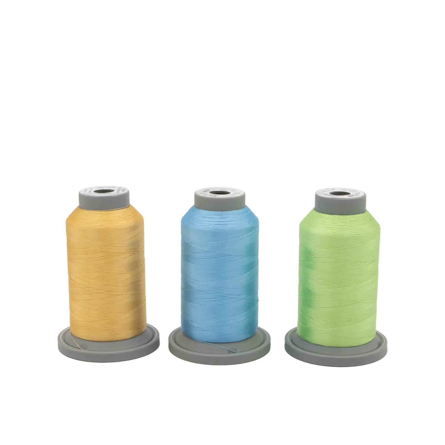 Three spools of Hab+Dash by Fil Tec's Sugar Stitches Glide Thread of the Month Bundle in yellow, blue, and green stand upright on gray bases against a plain white background—ideal for your stitching projects.