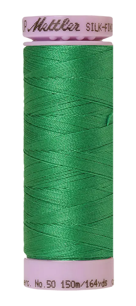 A spool of Mettler Cotton Silk Finish 50wt thread in Swiss Ivy (bright green), 150m/164yds, with a light purple top labeled "Mettler SILK-FIN" and No. 50 on the bottom.