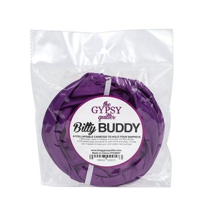 The Gypsy Quilter Bitty Buddy by Checker Distributor is a purple collapsible canister, packaged in a clear plastic bag with a label describing it as a handy scrap bag and fabric collector for sewing and quilting.