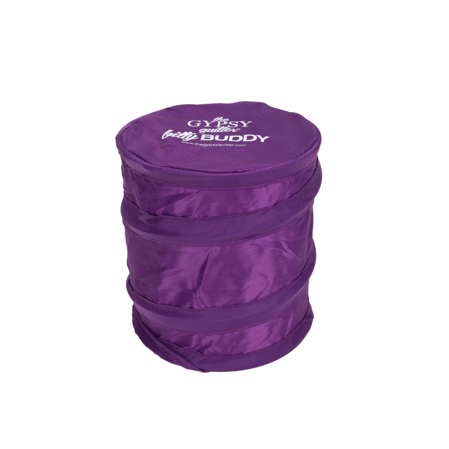 The Gypsy Quilter Bitty Buddy by Checker Distributor is a collapsible, round, purple fabric scrap collector with a white logo on top—perfect for sewing and quilting projects.