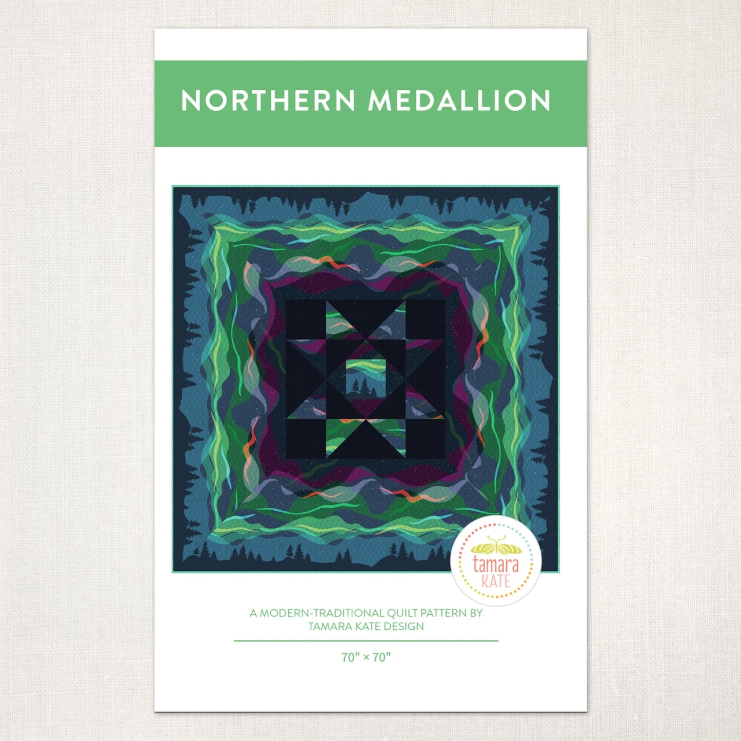 The Northern Medallion Quilt Pattern by Checker Distributor features a colorful medallion design with blue, green, and purple geometric and wavy motifs, accented by double-border prints. Finished size: 70" x 70". Design by Tamara Kate.