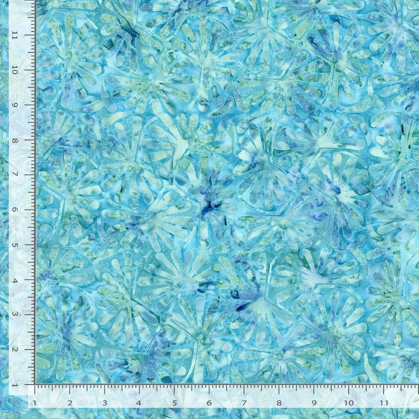A blue and green Tonga Mermaid Horse Chestnut Leaves Batik Fabric from Timeless Treasures Fabrics with an abstract leaf pattern, shown next to a ruler marked in inches. The sample measures approximately 12 inches square.