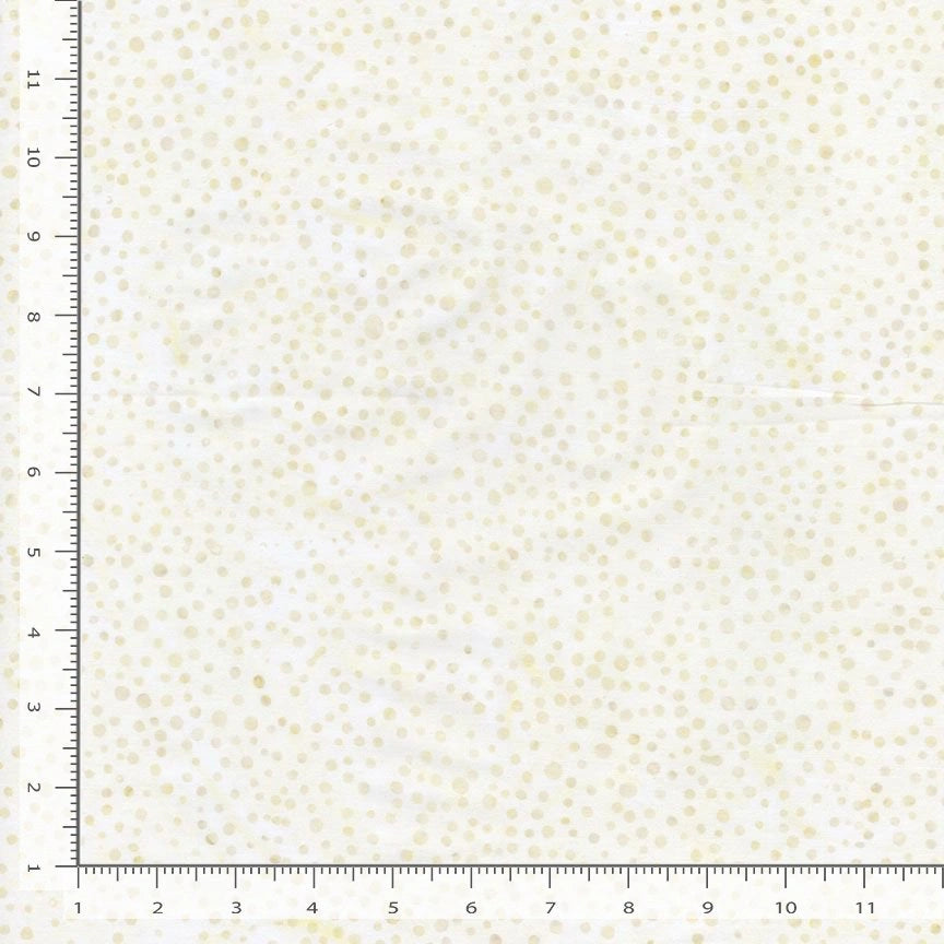 The Tonga Almond Sprinkles Batik Fabric Yardage is a white quilting cotton batik featuring small, scattered beige dots. Centimeter-marked rulers along the edges show the sample size.