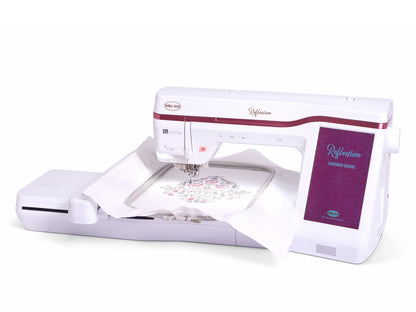 A Baby Lock Reflection Sewing & Embroidery machine with FREE 60 Days of Online Classes is stitching a floral pattern onto white fabric held in an embroidery hoop.