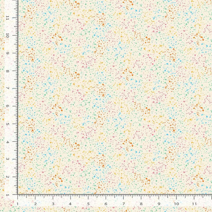 A ruler frames two edges of a Dear Stella Stardust Rainbow 108" Wide 3 Yard Quilt Fabric Back Pack sample, featuring a cream background with scattered orange, blue, pink, and green dots. The cotton swatch is about 12" x 12".