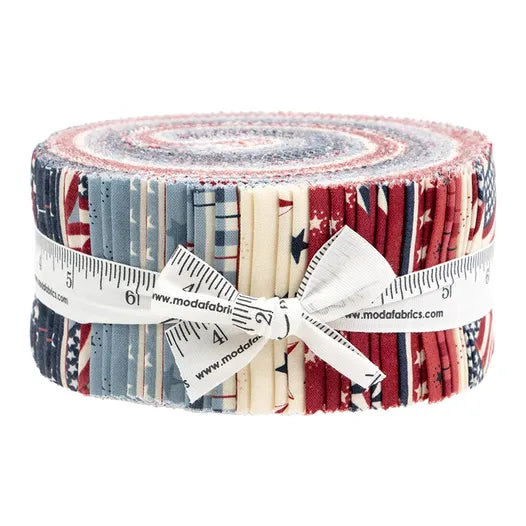 The United Notions America 250 Years Jelly Roll features red, white, and blue fabric strips in patriotic patterns, all rolled up and tied with a measuring tape-style ribbon.