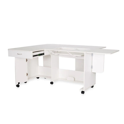 The Arrow Christa Sewing and Quilting Machine Cabinet by Arrow Companies, LLC is a white L-shaped cabinet with a fold-out side, adjustable center lift, storage drawer, cabinet and open shelves, plus wheels for easy mobility during crafting or sewing projects.