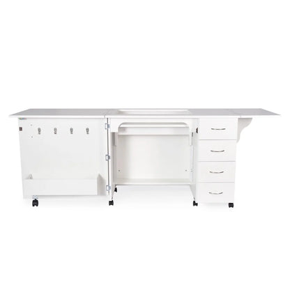 The Arrow Harriet Sewing and Quilting Machine Cabinet by Arrow Companies, LLC is a white multifunctional cabinet on wheels with four drawers, a central open compartment, left section storage hooks, and fold-out panels for machine storage.