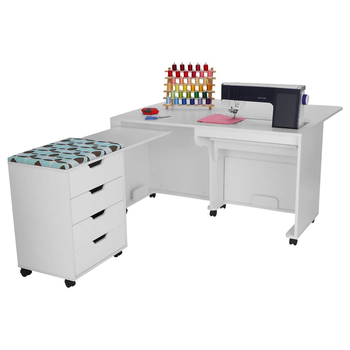 The Arrow Laverne and Shirley Sewing and Quilting Machine Cabinet by Arrow Companies, LLC is a white L-shaped unit with drawers, a cushioned wheeled seat, storage for thread spools, and room for your sewing machine and accessories. Wheels allow easy movement.