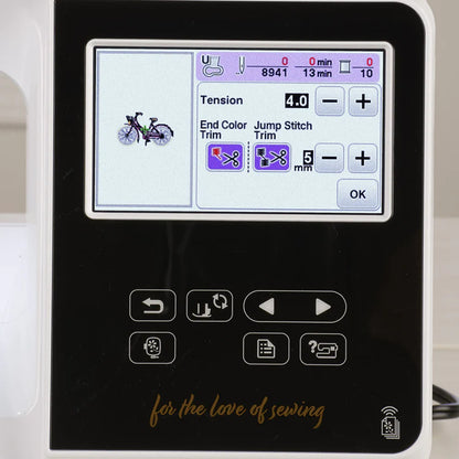 The Baby Lock Flare Dedicated Embroidery Machine with FREE Online Classes features a digital display showing a bicycle design, tension at 4.0, trim options, embroidery fonts, various buttons and icons, and "for the love of sewing" below the screen.