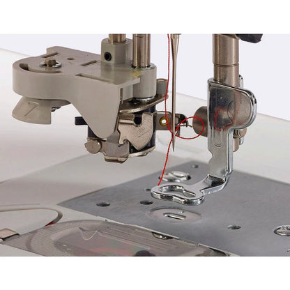 Close-up of a Baby Lock Flare Dedicated Embroidery Machine with red thread through the needle and presser foot, above a metal needle plate. Includes FREE online classes—ideal for creating unique embroidery fonts.