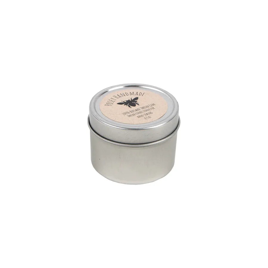 A small, round silver tin with a fitted lid and a beige label featuring a bee graphic contains United Notions Thread Gem 100% Beeswax Thread Conditioner. The item is shown on a plain white background.