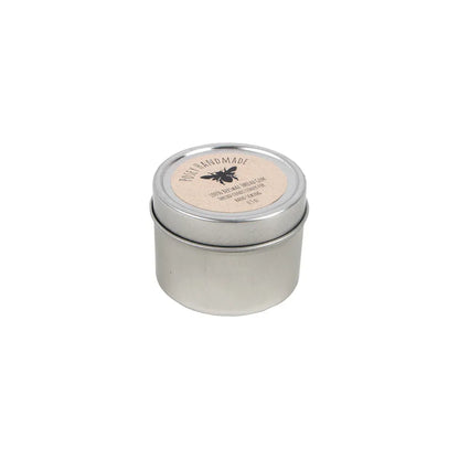 A small, round silver tin with a fitted lid and a beige label featuring a bee graphic contains United Notions Thread Gem 100% Beeswax Thread Conditioner. The item is shown on a plain white background.