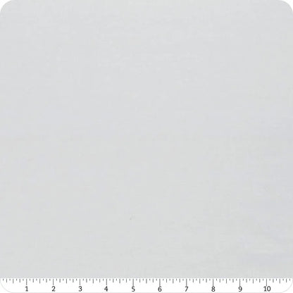 A close-up of United Notions’ Bella Solids Zen Gray Junior Jelly Roll fabric, with a ruler showing inches 1–12 along the bottom edge, highlights its scale and texture—ideal for quilting projects.