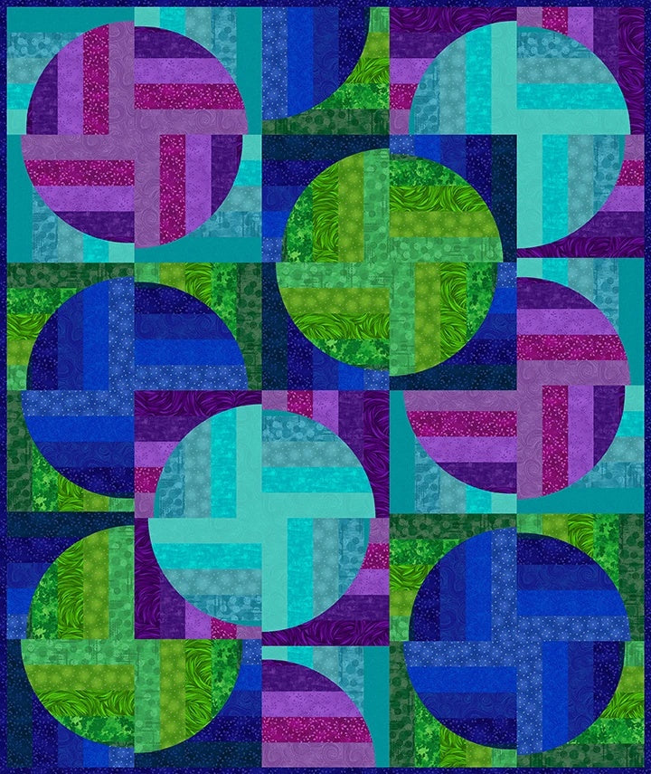 The Time After Time Quilt Kit by Quilted Joy features jewel-toned fabrics in blue, green, and purple, with interlocking circles and rectangles highlighted by geometric and textured patterns.