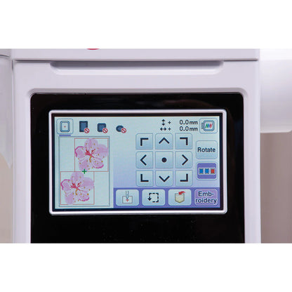 Close-up of the Baby Lock Bloom Sewing & Embroidery Machine screen showing editing and rotation controls, plus two pink flower embroidery designs on the touchscreen interface. Brand: Baby Lock.